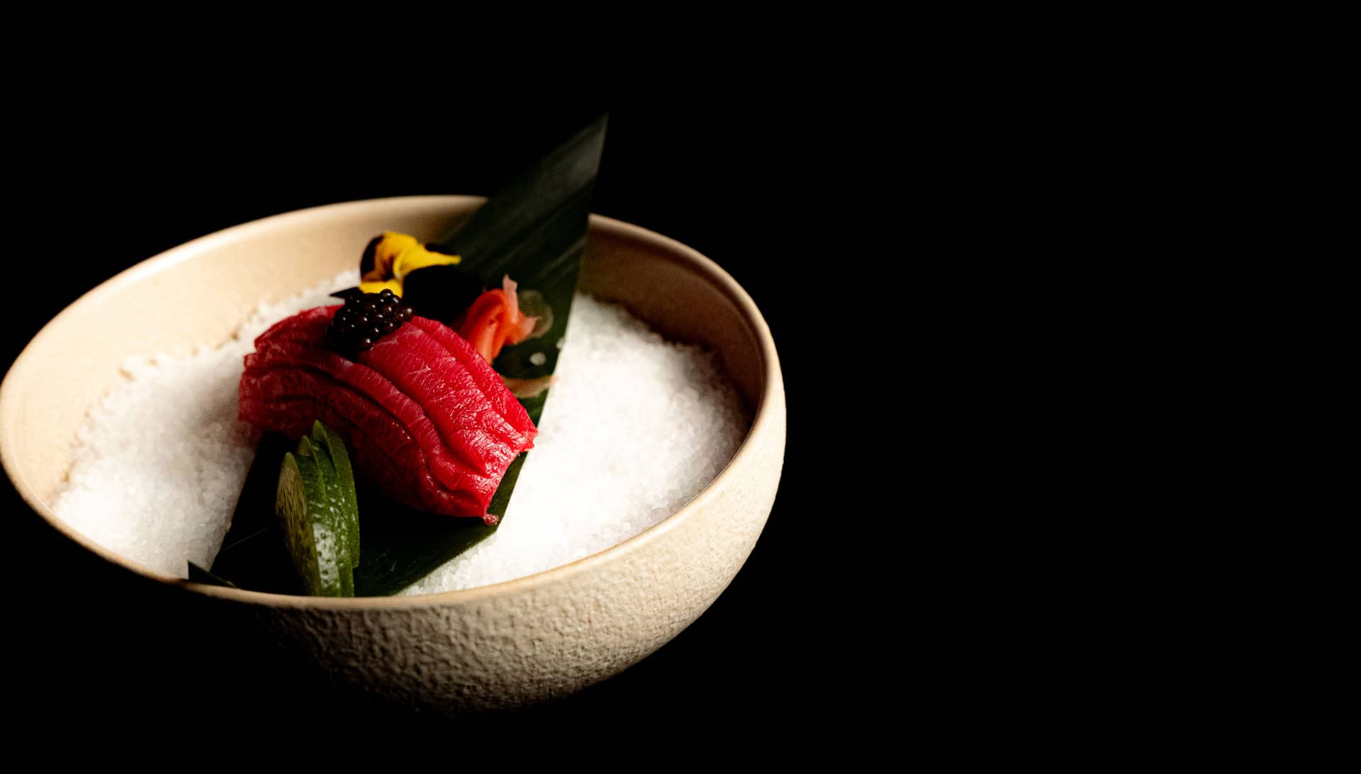 Balfegó bluefin chutoro nigiri topped with caviar in a beige bowl at OKOZ Antwerp